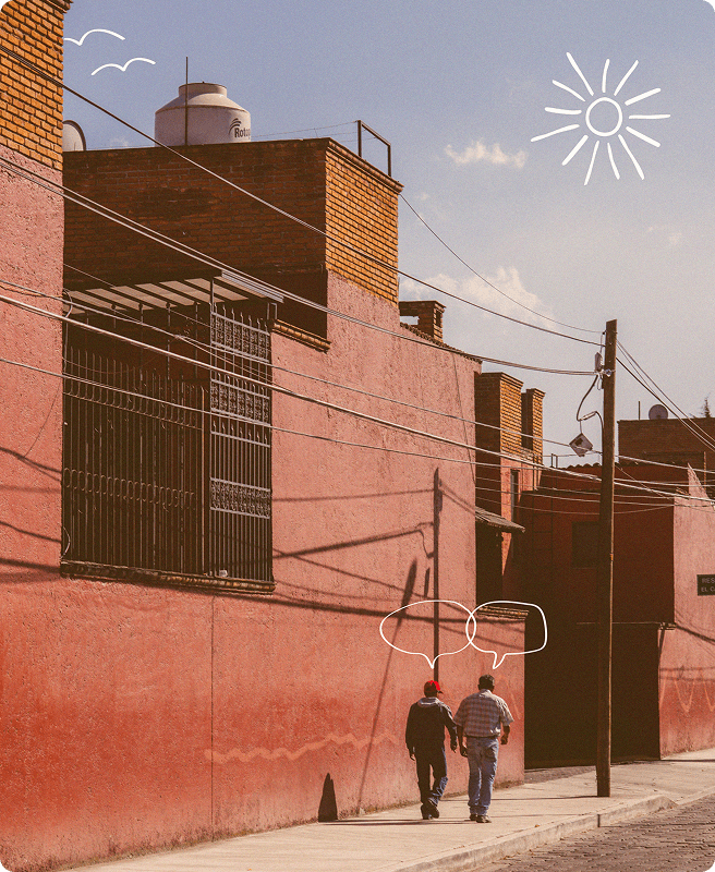 Two people walking down a street